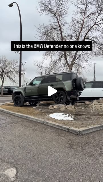 Reel: a green Land Rover Defender parked on a kerb